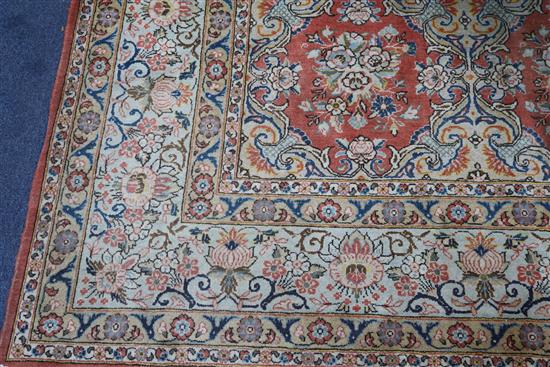 A Persian brick red ground carpet, 331 x 231cm